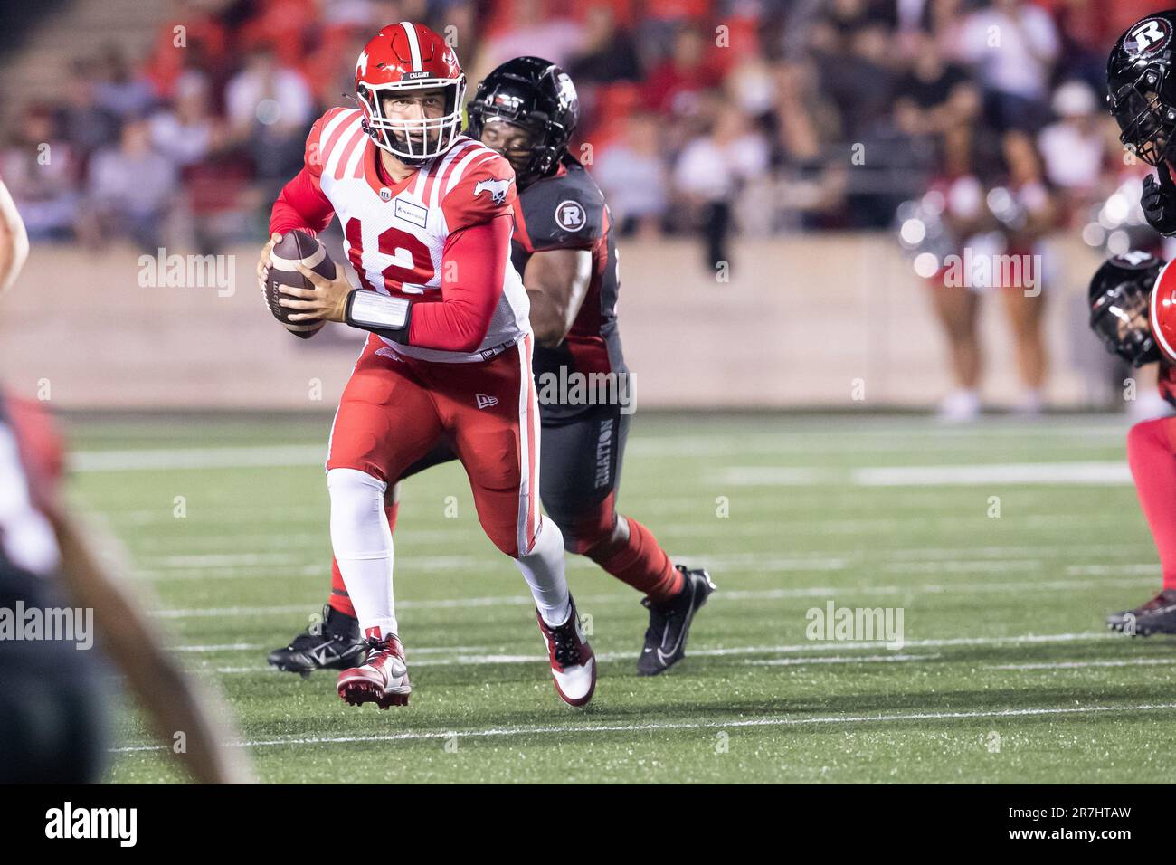 Ottawa, Canada. 15th June, 2023. Calgary Stampeders quarterback Jake Maier (12) runs while looking to pass during the CFL game between Calgary Stampeders and Ottawa Redblacks held at TD Place Stadium in Ottawa, Canada. Daniel Lea/CSM/Alamy Live News Stock Photo