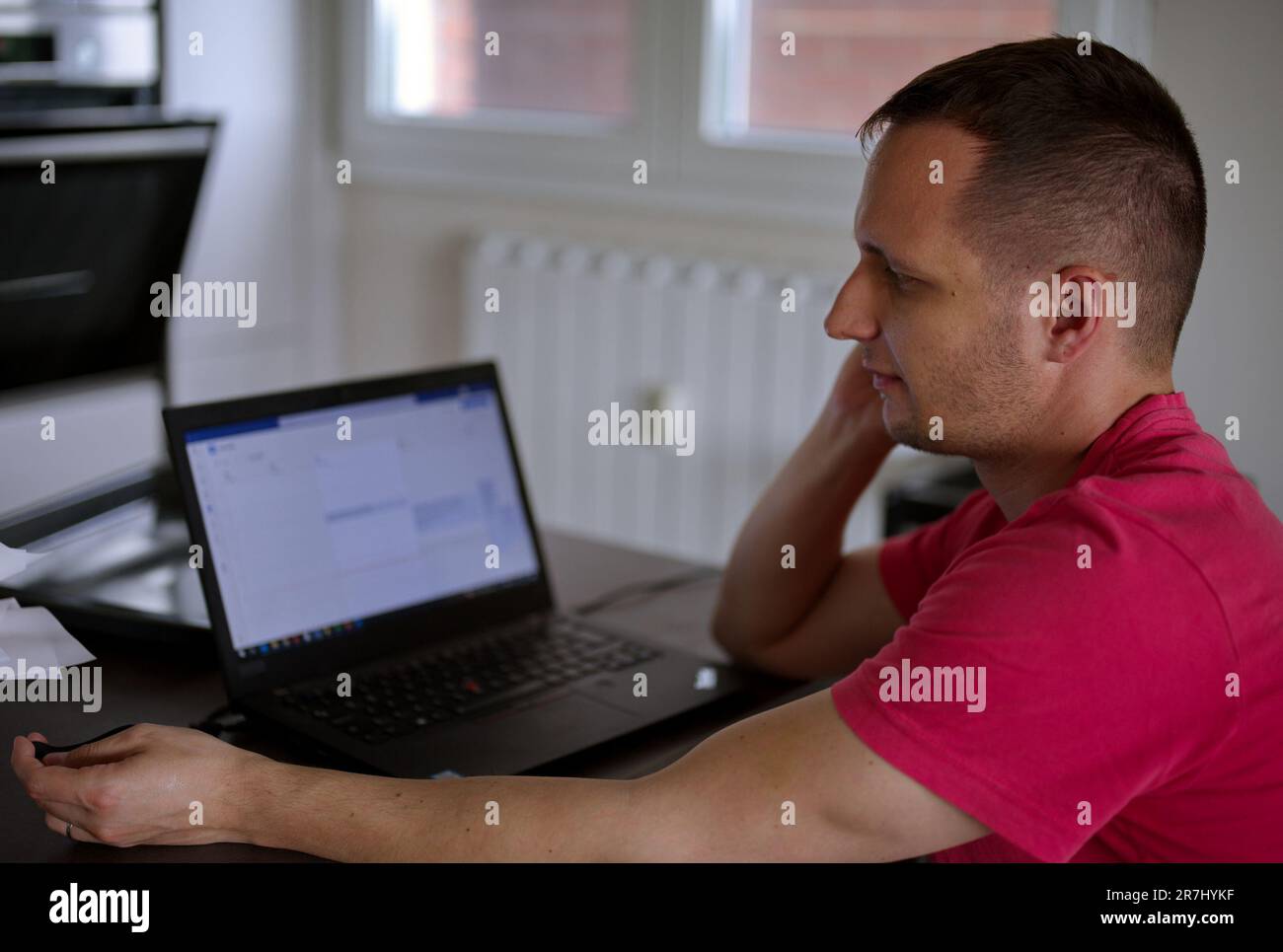 Mature man sitting at home and using laptop Stock Photo