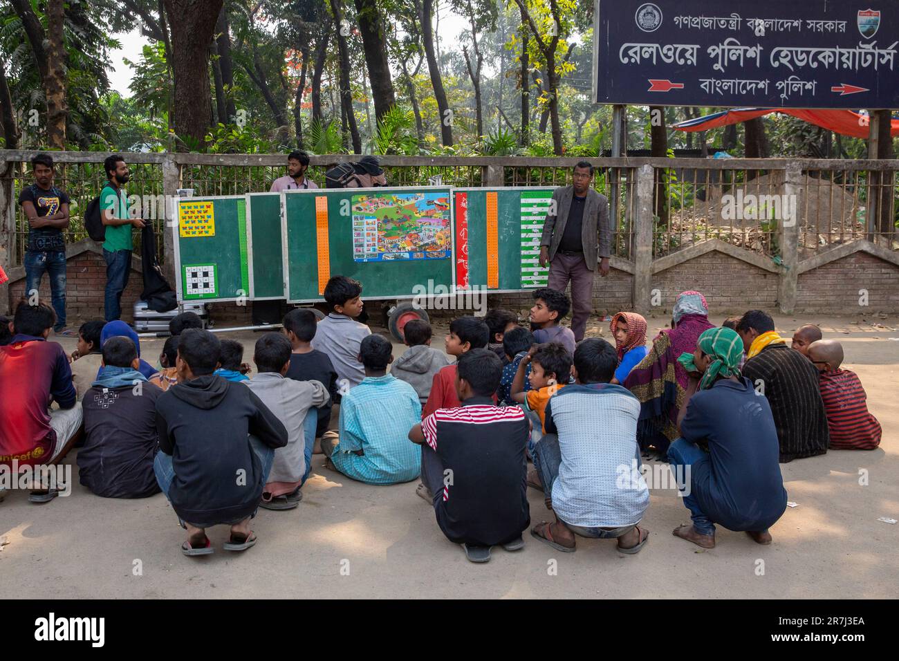 Homeless street people learn in a roadside school at Kamlapur Railway Station in Dhaka, Bangladesh Stock Photo
