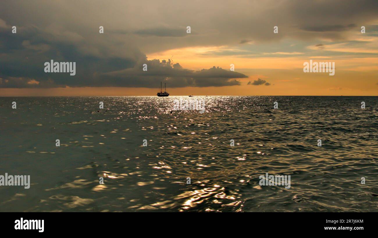 sailing ship on the horizon against the sunset sky Stock Photo - Alamy