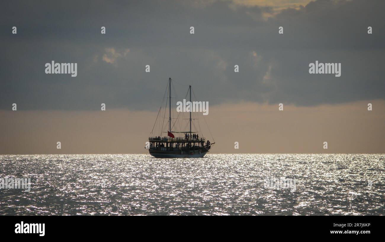 sailing ship on the horizon against the sunset sky Stock Photo - Alamy