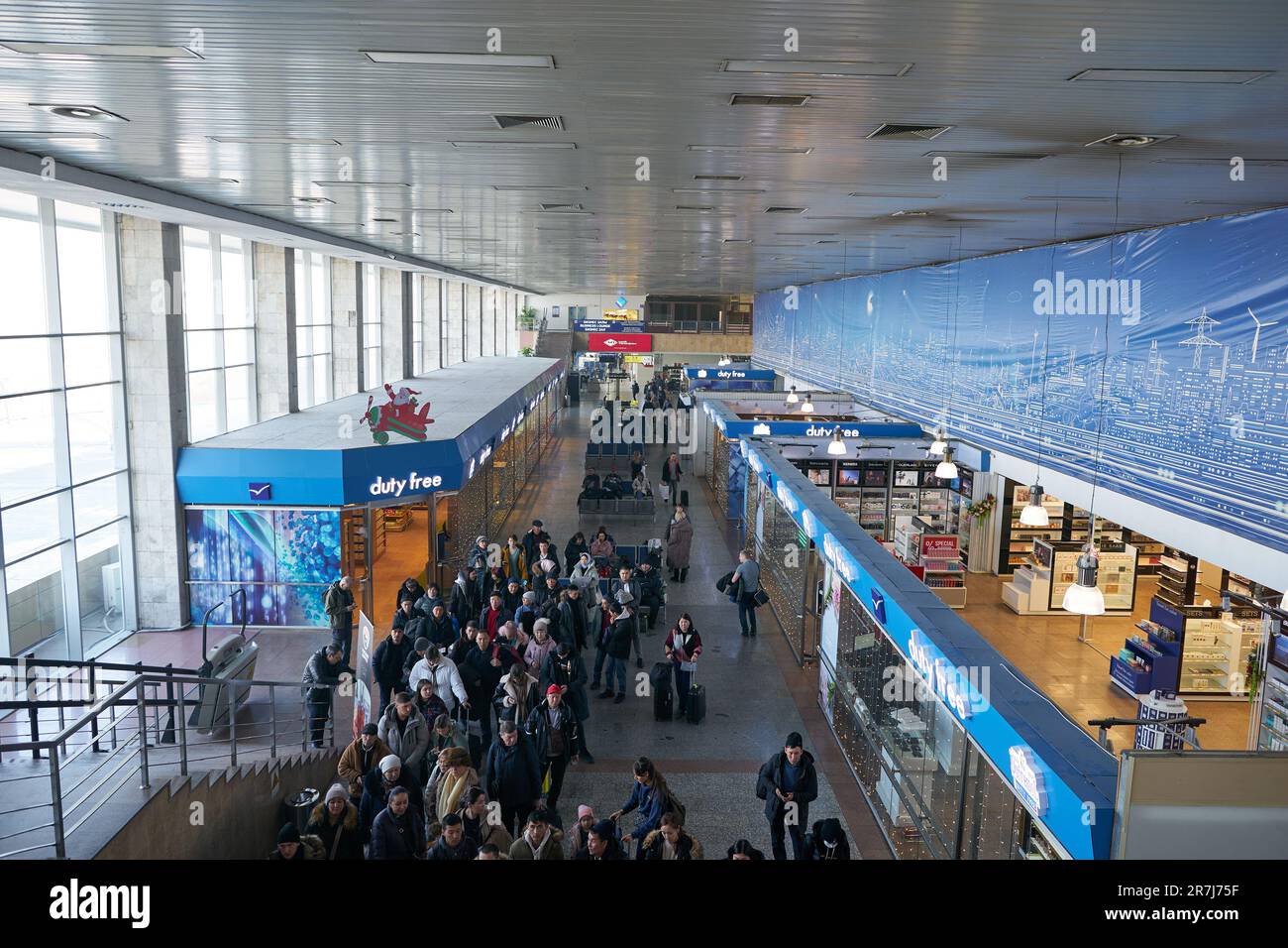 BISHKEK, KYRGYZSTAN - CIRCA JANUARY, 2023: people stand in line at Manas International Airport. Stock Photo