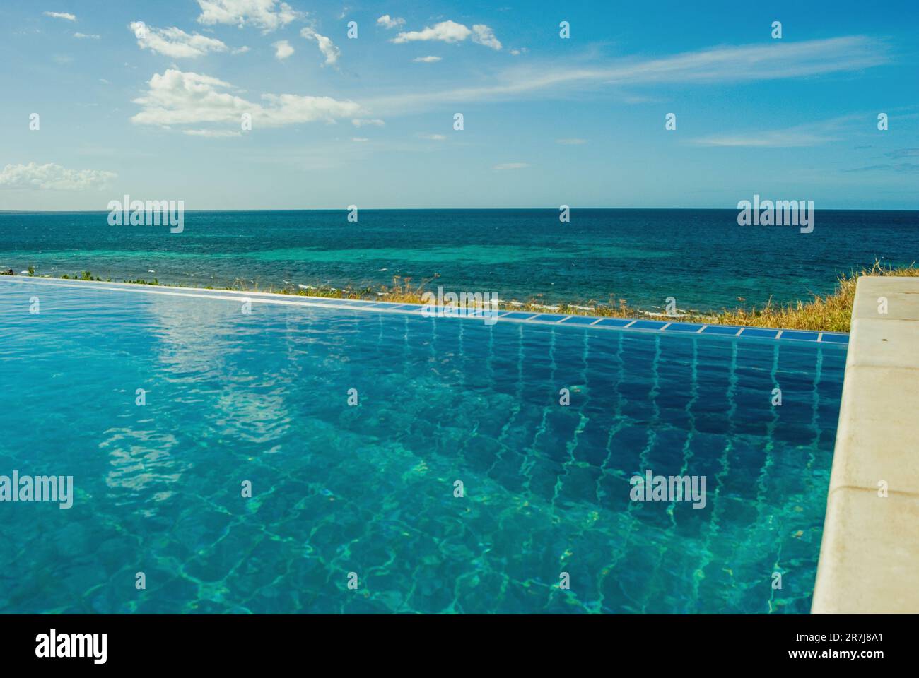 Swimming pool and the Indian Ocean, Pemba Mozambique. Stock Photo