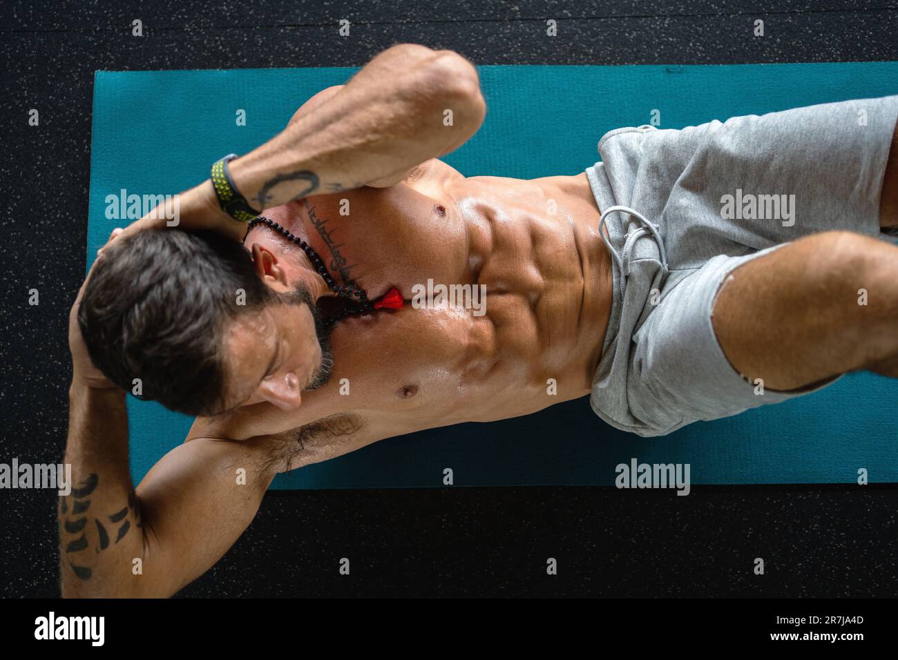 Top view of a strong man doing crunches on a mat in a gym Stock Photo Alamy