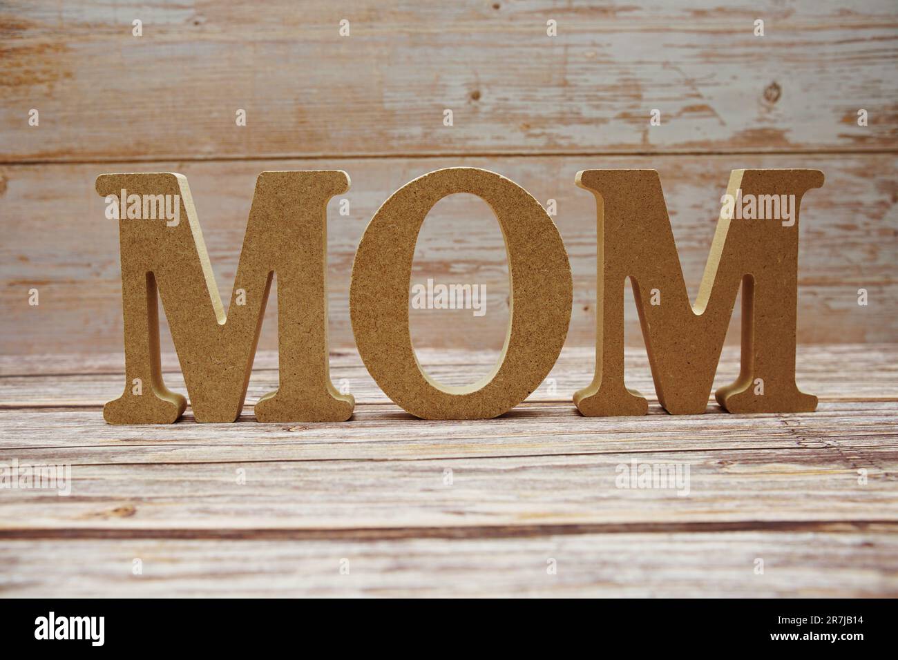 Mom alphabet letters on wooden background Stock Photo - Alamy