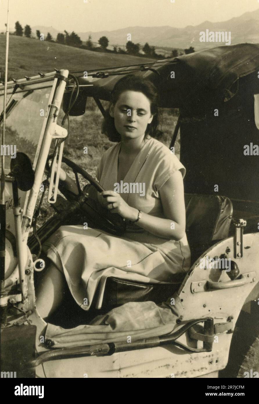 Woman driving a military Willis Jeep car, Italy 1950s Stock Photo