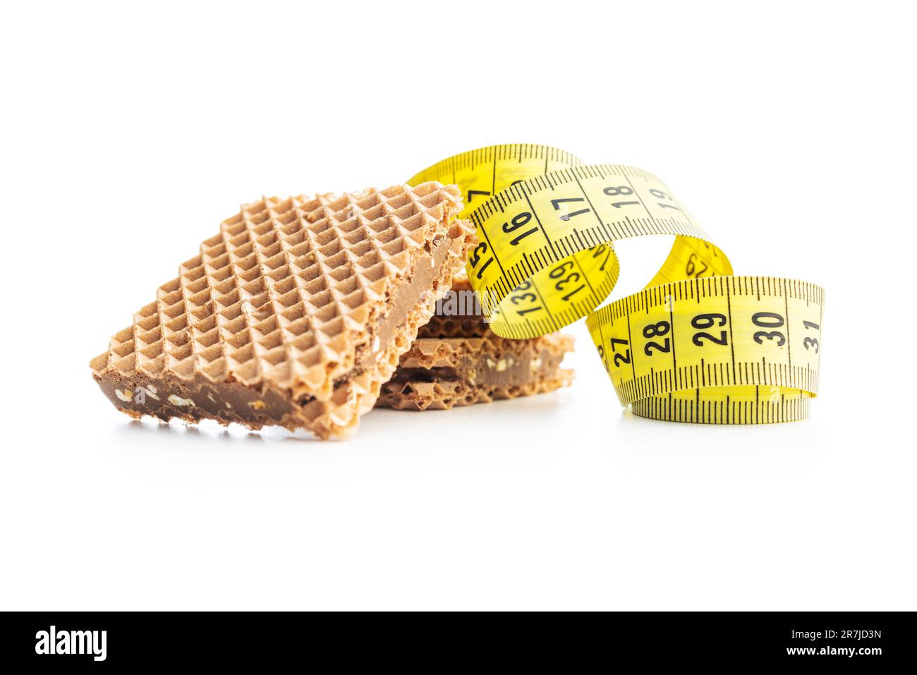 Sweet chocolate wafer and measuring tape isolated on the white background. Stock Photo