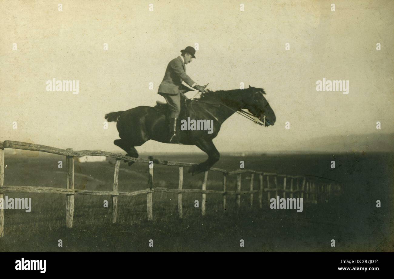 Man horse jumping in the countryside, Italy 1920s Stock Photo