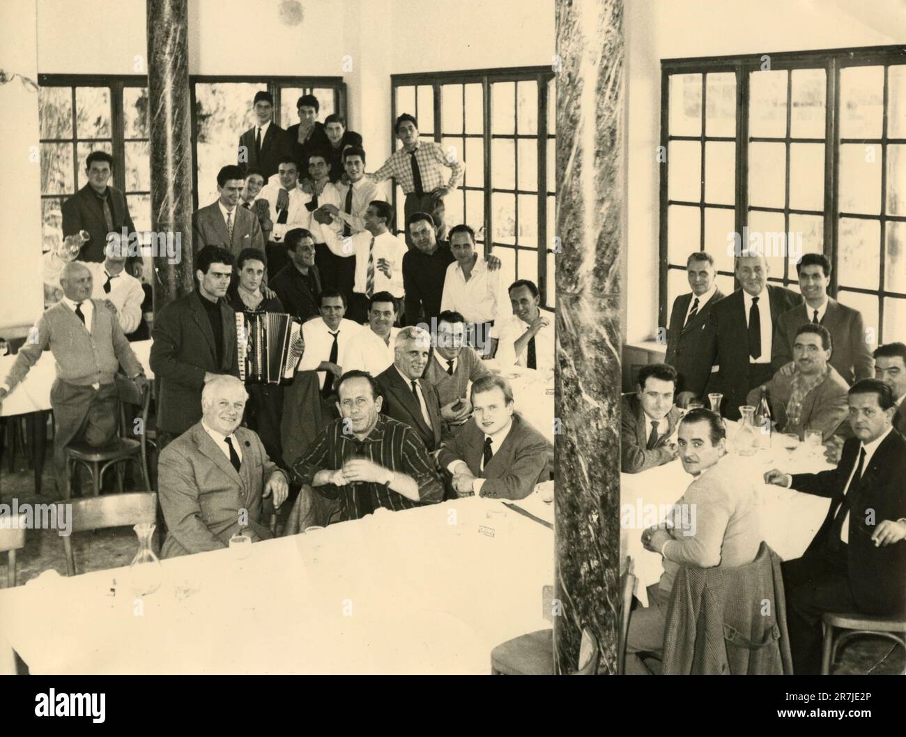Large group of people at a restaurant with a U-shaped table, Italy 1960s Stock Photo