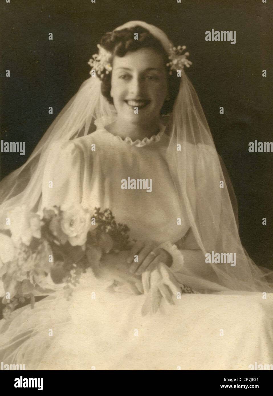Portrait of a smiling beautiful bride dressed in white, Italy 1930s Stock Photo