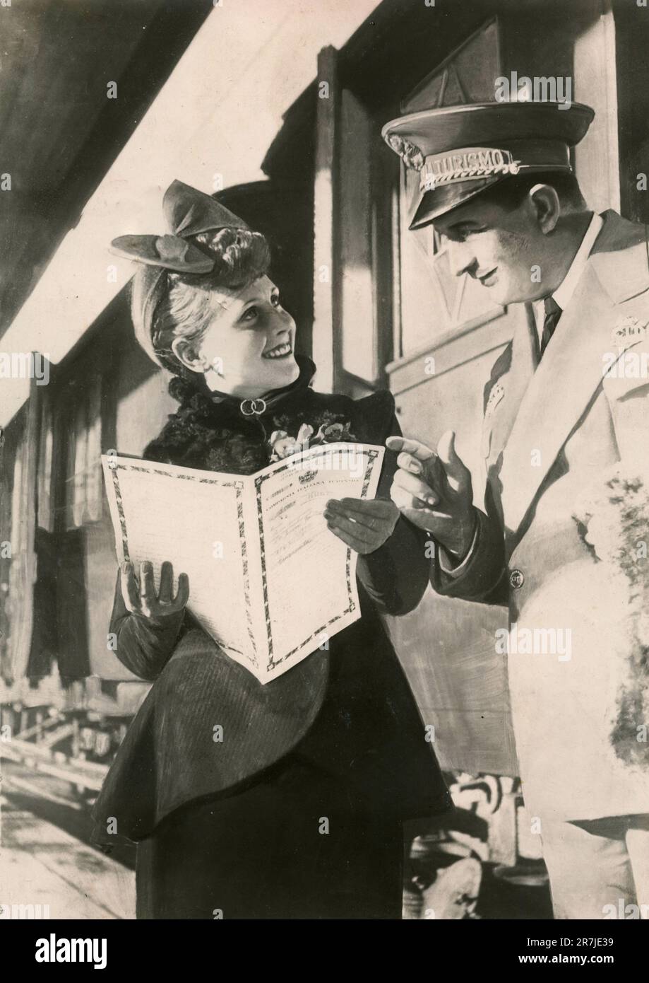 Railway advertisement of a woman asking information to the conductor, Italy 1930s Stock Photo