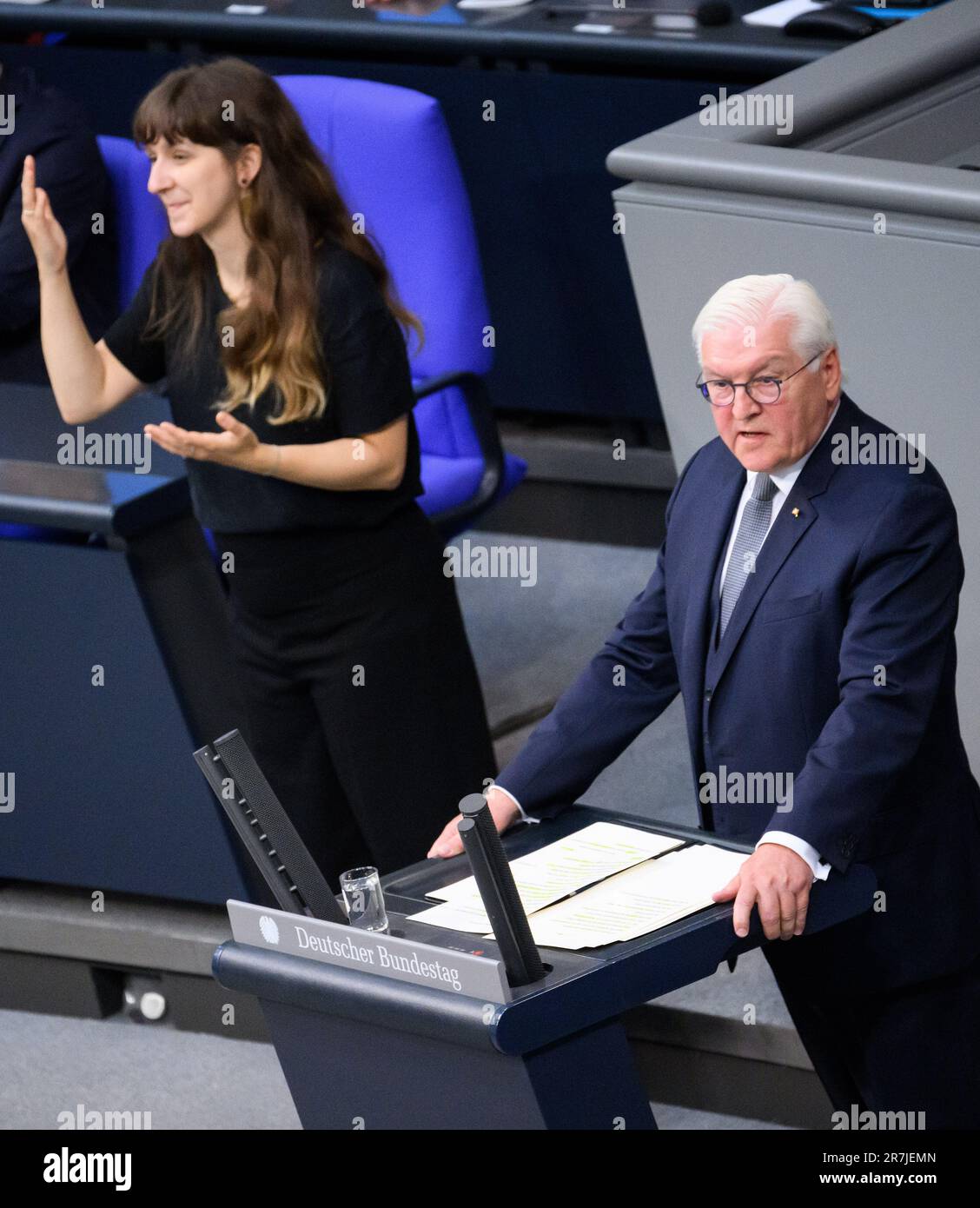 16 June 2023, Berlin: German President Frank-Walter Steinmeier speaks at a commemoration of the 70th anniversary of the popular uprising in the GDR in the German Bundestag. A sign language interpreter stands next to him. On June 17, 1953, up to one million people had protested in East Berlin and 700 other places in the GDR. They demonstrated against higher labor standards, but also against the Socialist Unity Party SED, for free elections and more prosperity. Soviet troops stationed in the GDR and the People's Police cracked down on the protests, sometimes with tanks. At least 55 people were k Stock Photo