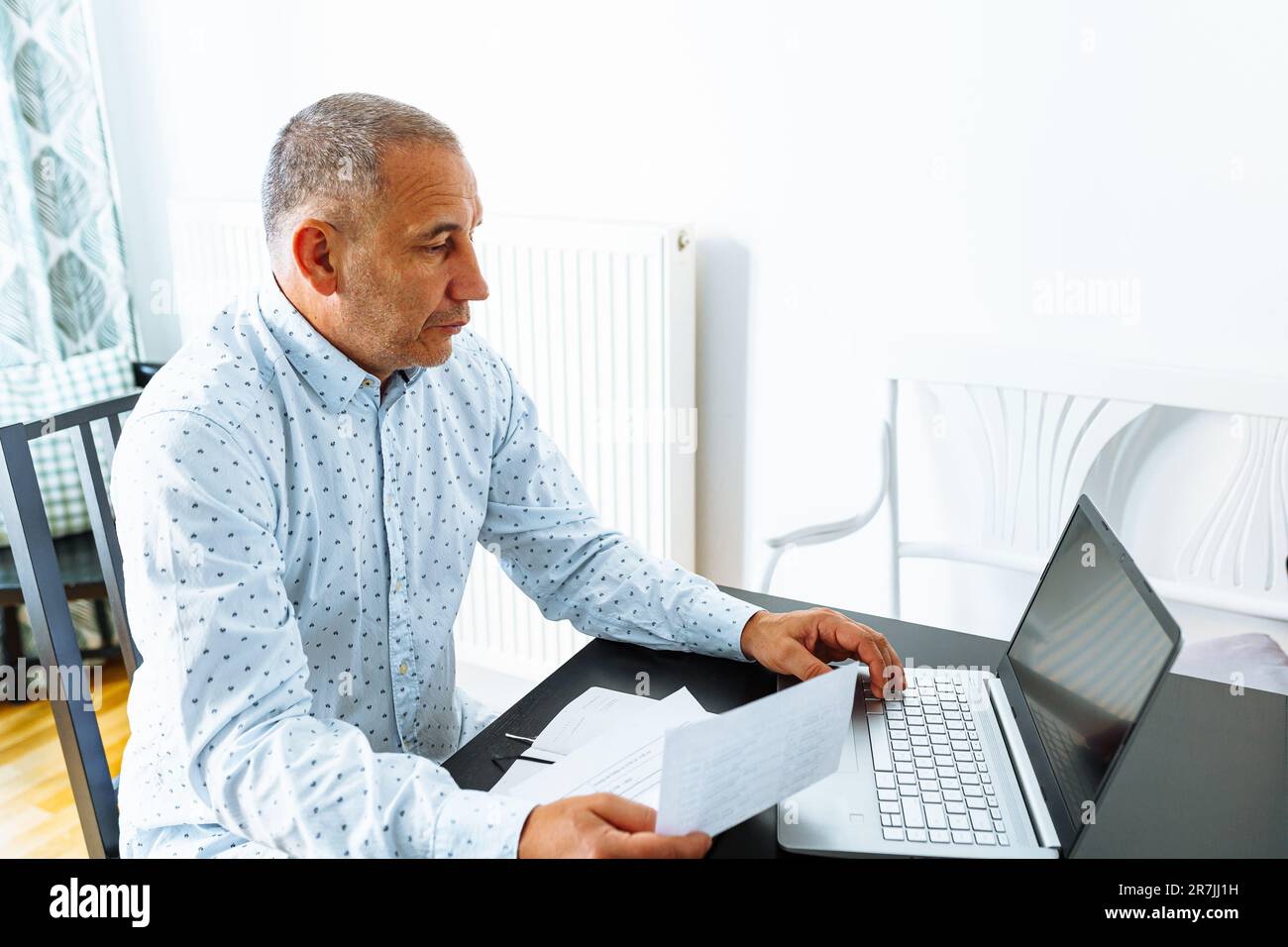 Portrait middle-aged man making notes in notebook Stock Photo