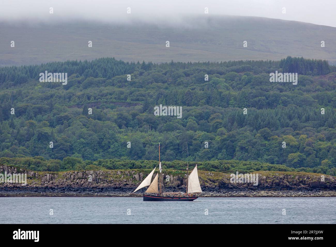 Large Classic Two-masted Sailboat in the Sound of Mull near to the Coast, Isle of Mull, Inner Hebrides, Inner Isles, Scotland, United Kingdom Stock Photo
