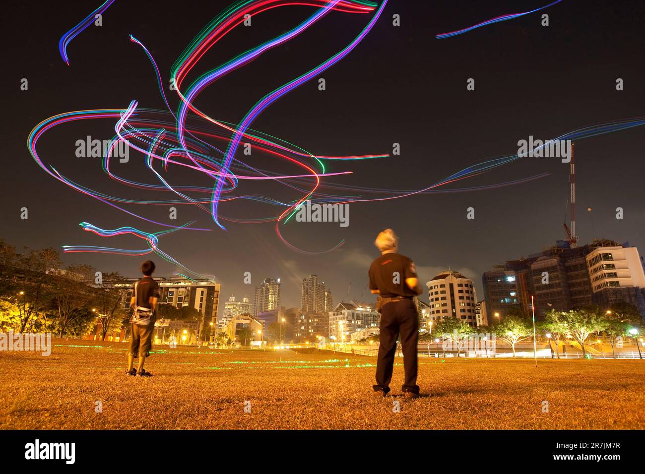 Members of the Singapore Night Flyer Kite club light up the evening sky with remote controlled kites adorned with colorful LED lighting. Stock Photo