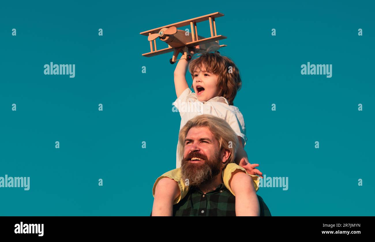 Father and son playing with wooden airplane. Family Time Together. Family dream. Child dreams with plane. Father and son dream. Daydreamers. Dreams an Stock Photo