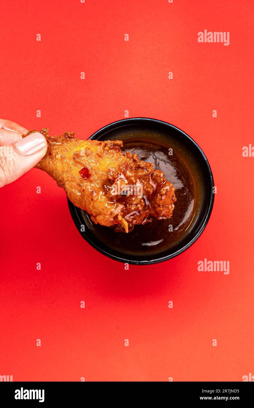 Image of a bowl of fried chicken wings drizzled with a spicy-sweet Buffalo sauce Stock Photo