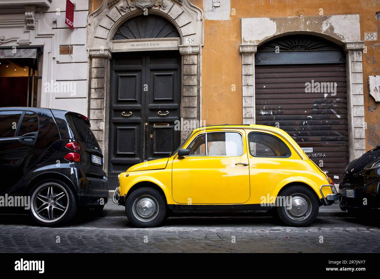 A vintage yellow car on a side street in Paris, France Stock Photo Alamy