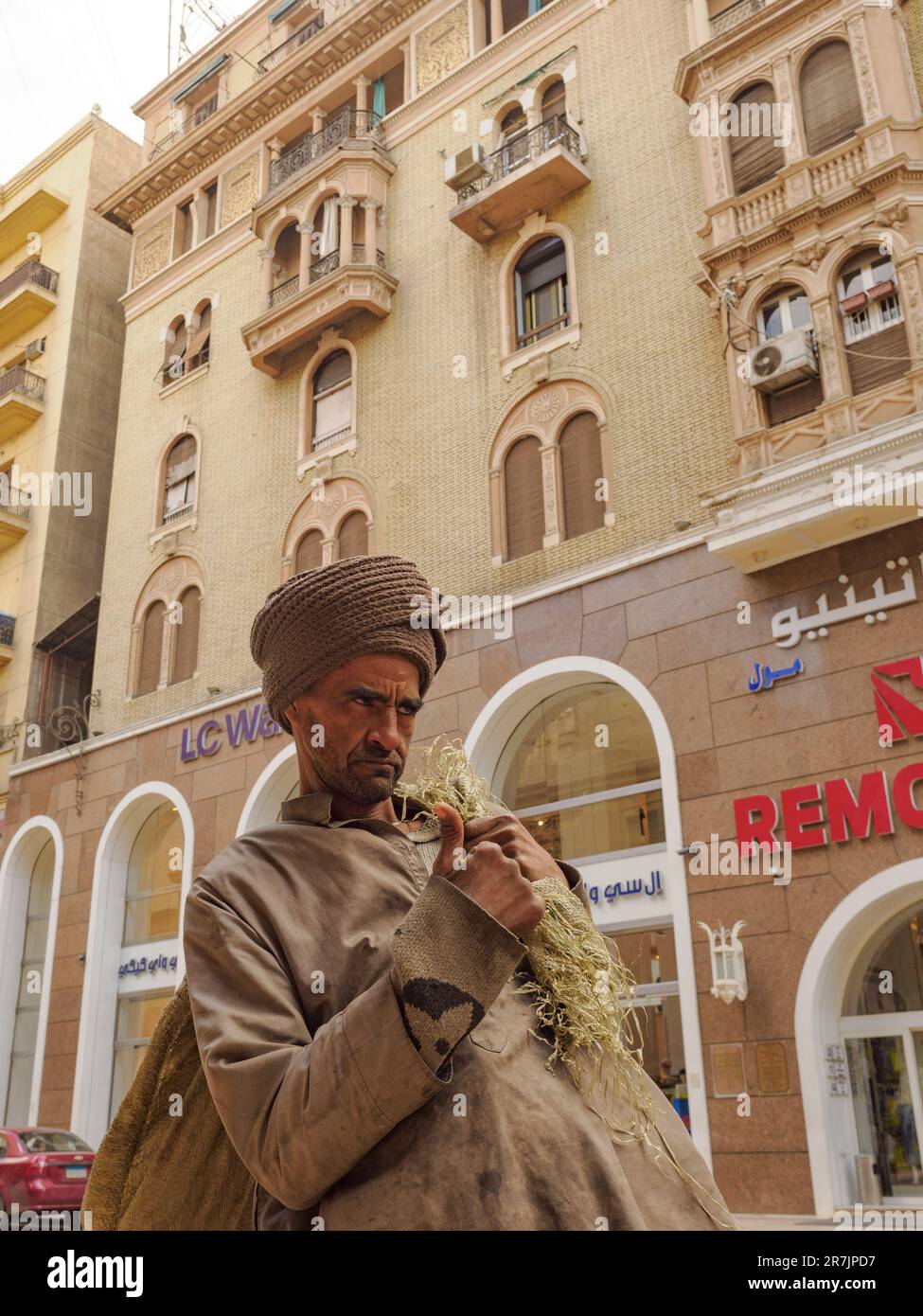 Man in Turban and Poor Clothes on Cairo Street, Near Historic Bu Stock Photo