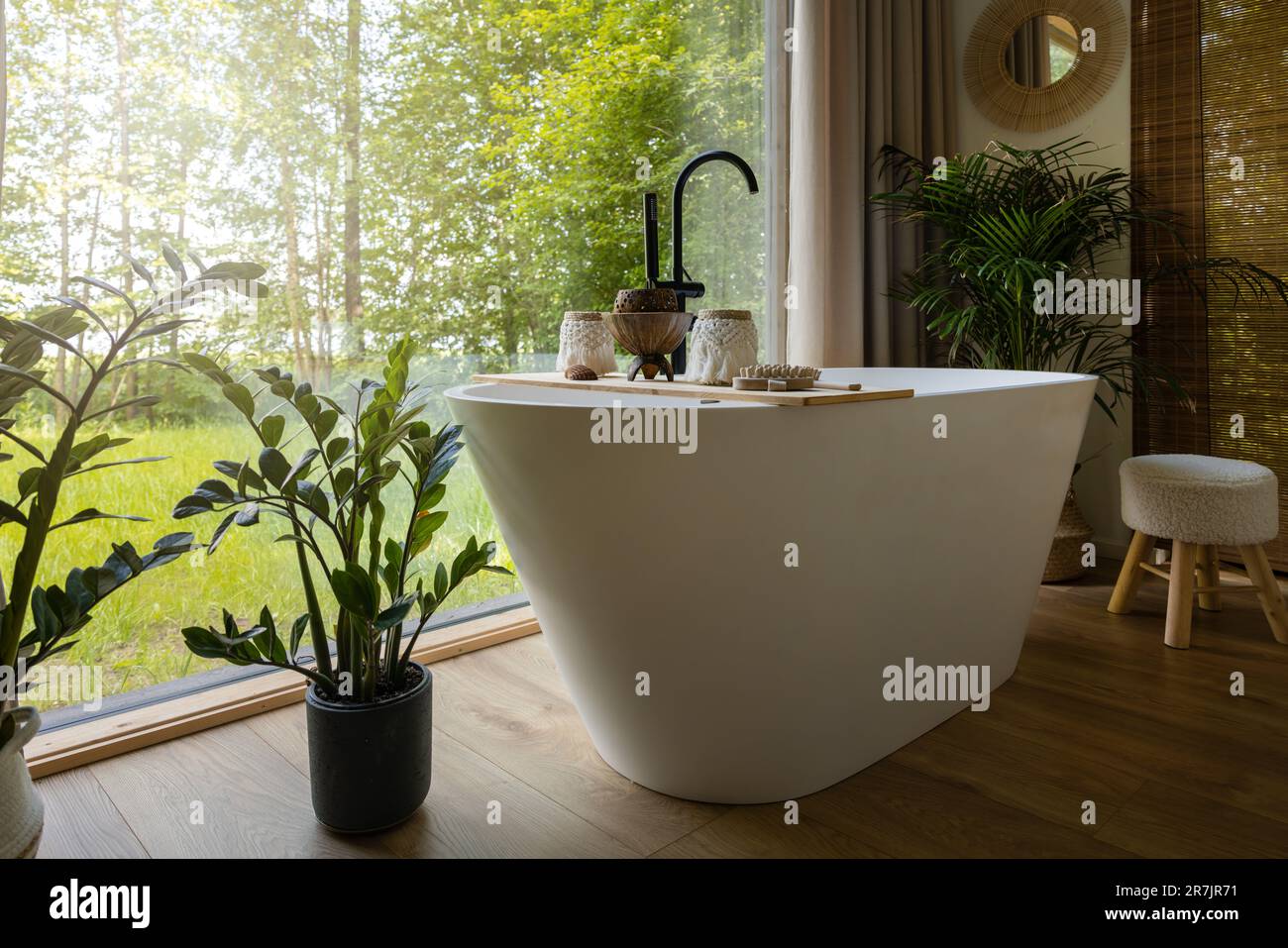 bedroom interior with white bathtub by the window Stock Photo - Alamy