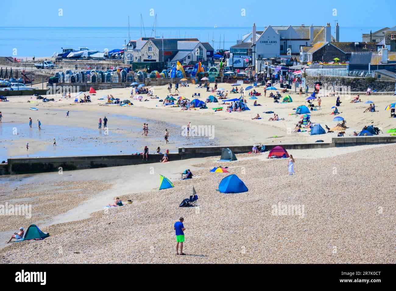 Lyme Regis, Dorset, UK. 16th June, 2023. UK Weather: Sunworshippers flock to the seaside resort of Lyme Regis to soak up the scorching hot sunshine as the June heatwave continues. Credit: Celia McMahon/Alamy Live News Stock Photo