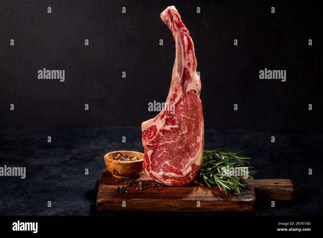 Raw Tomahawk beef steak and spices. Ready for grilling Stock Photo