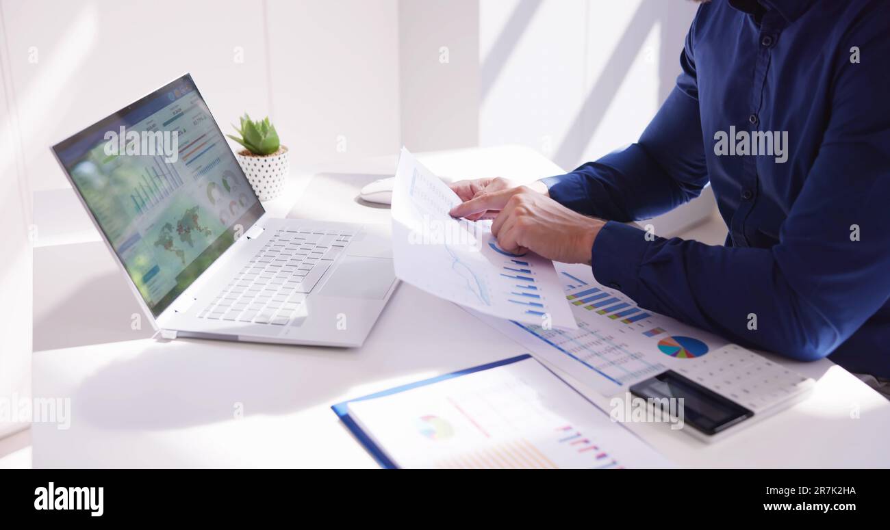 Business Accountant Using Finance Chart Document And Calculator Stock Photo