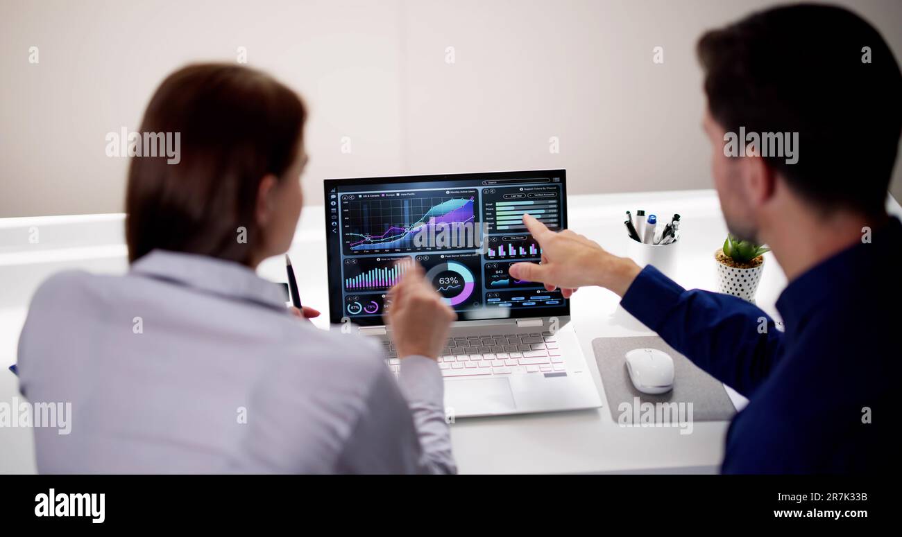 Two Analyst Using KPI Dashboard On Laptop Computer Stock Photo