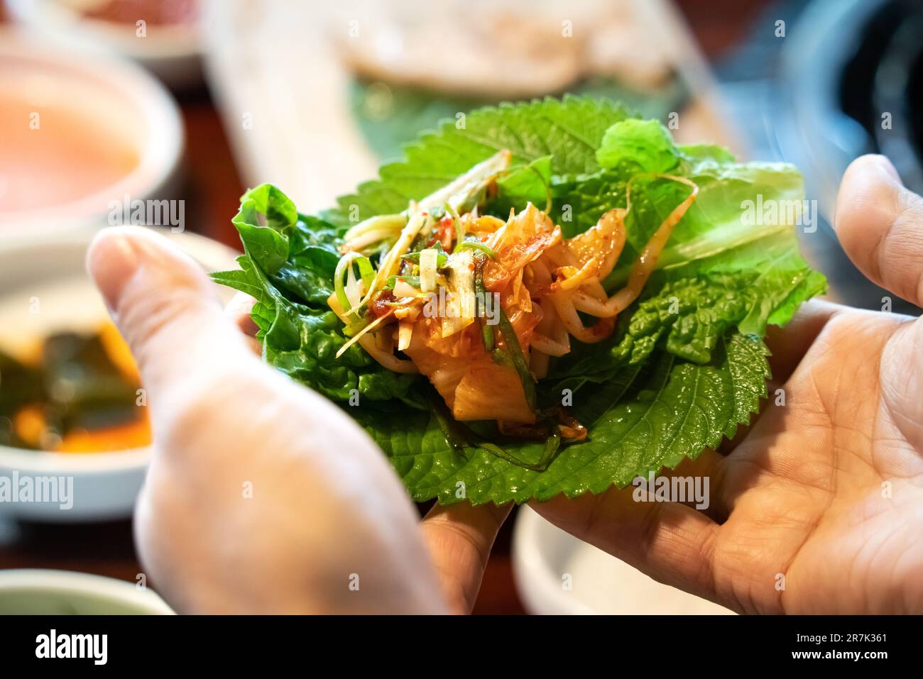 Pan-fried black pork meal in Jeju Korean restaurant, fresh delicious korean food cuisine on iron plate with lettuce, kimchi, banchan and sauce, lifest Stock Photo