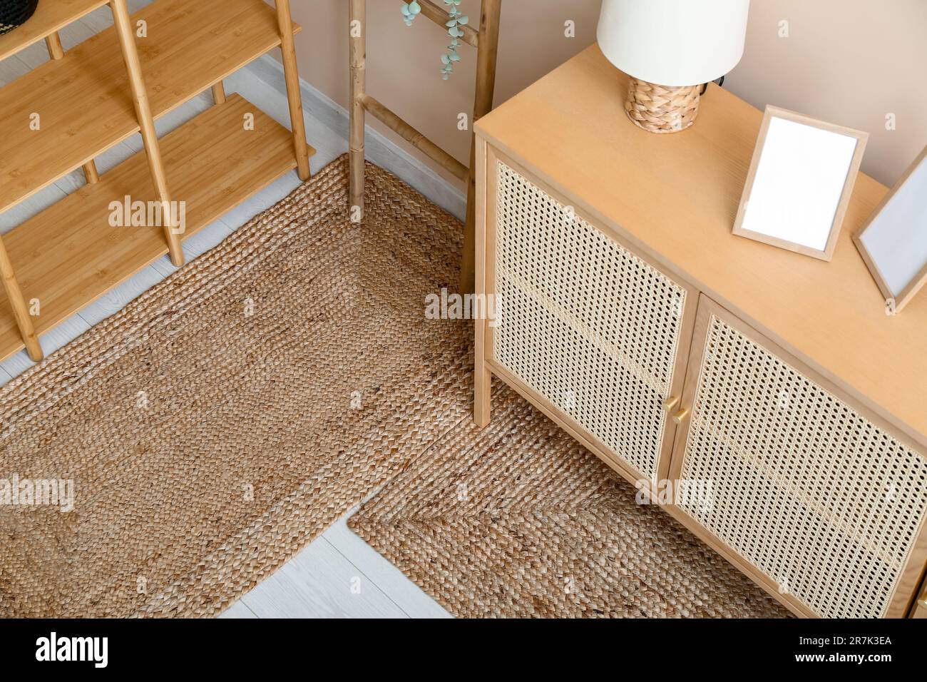 Stylish interior of living room with shelving unit, ladder, drawers and ...