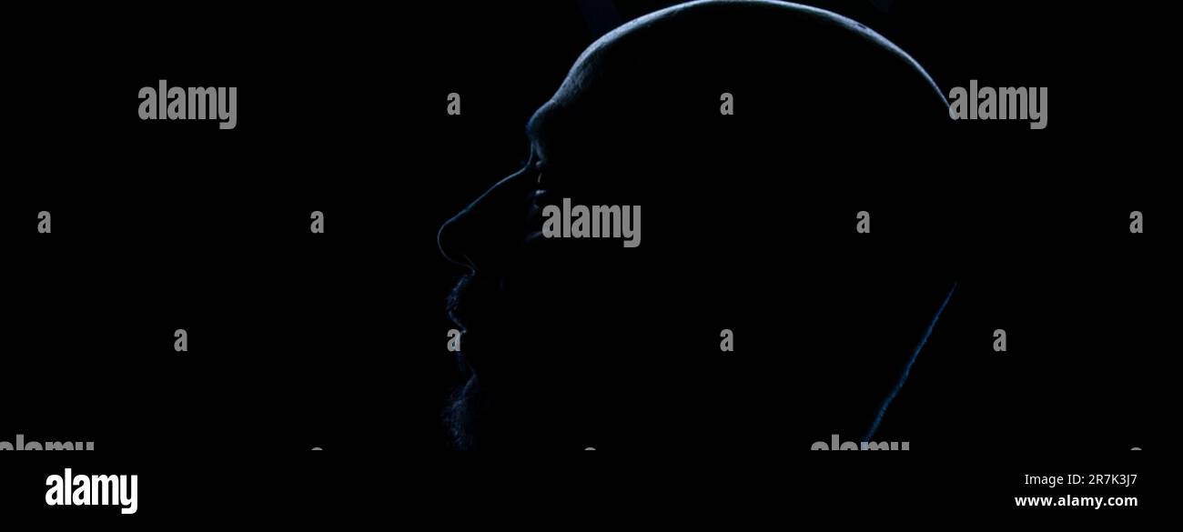 Silhouette of a man head in backlight. Studio portrait. Isolated on dark background. Stock Photo