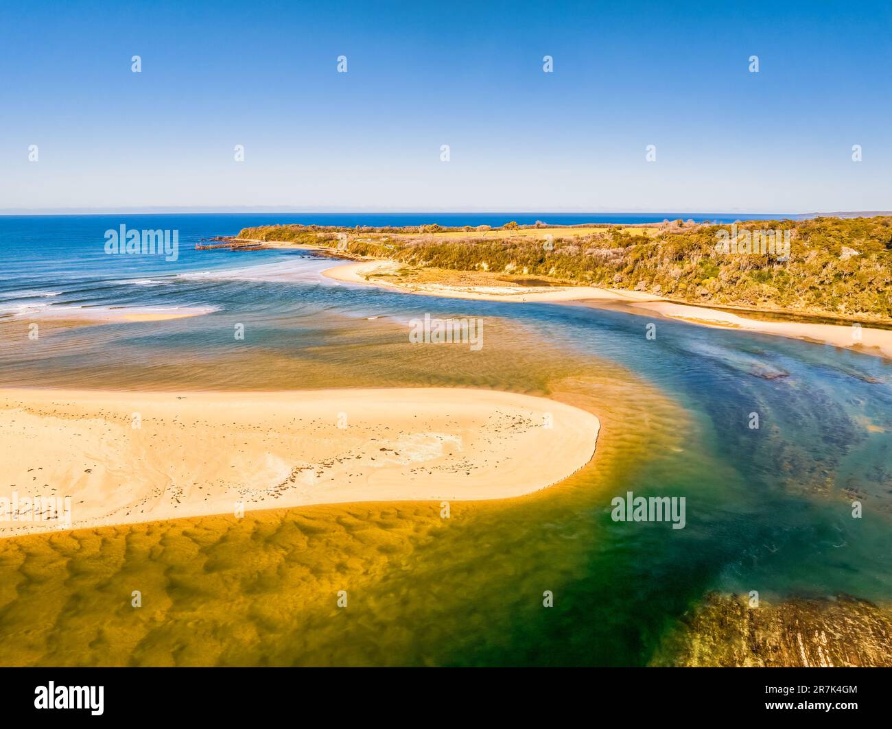 Blue sky daytime coast views over the sea and the Wallagaraugh River at Mallacoota, Victoria, Australia Stock Photo