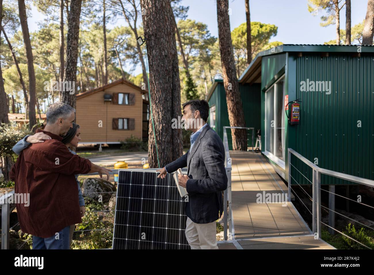 Consultant explaining solar powered station to home owners Stock Photo