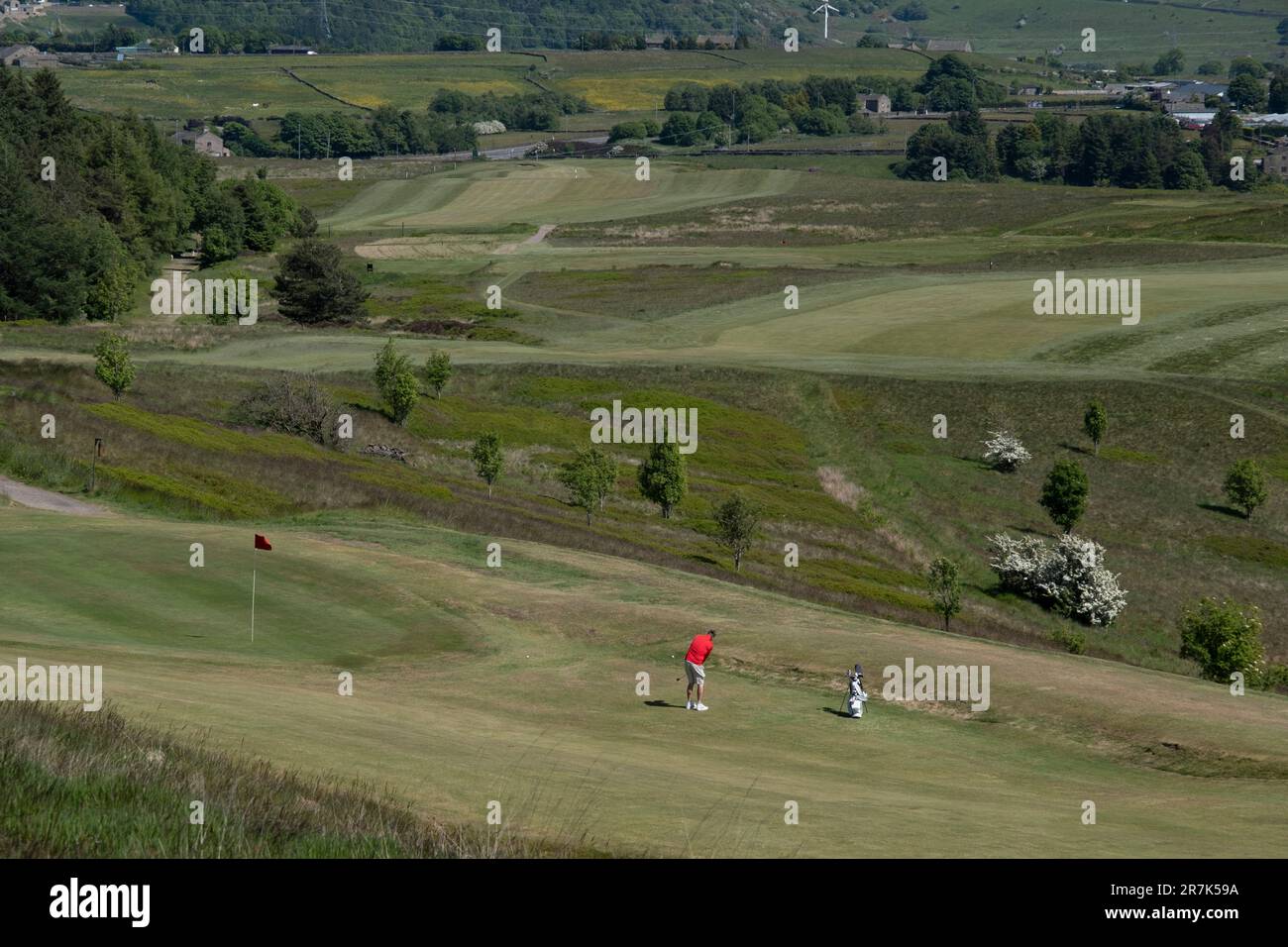View looking over Halifax Golf Club as a golfer wearinga. red shirt