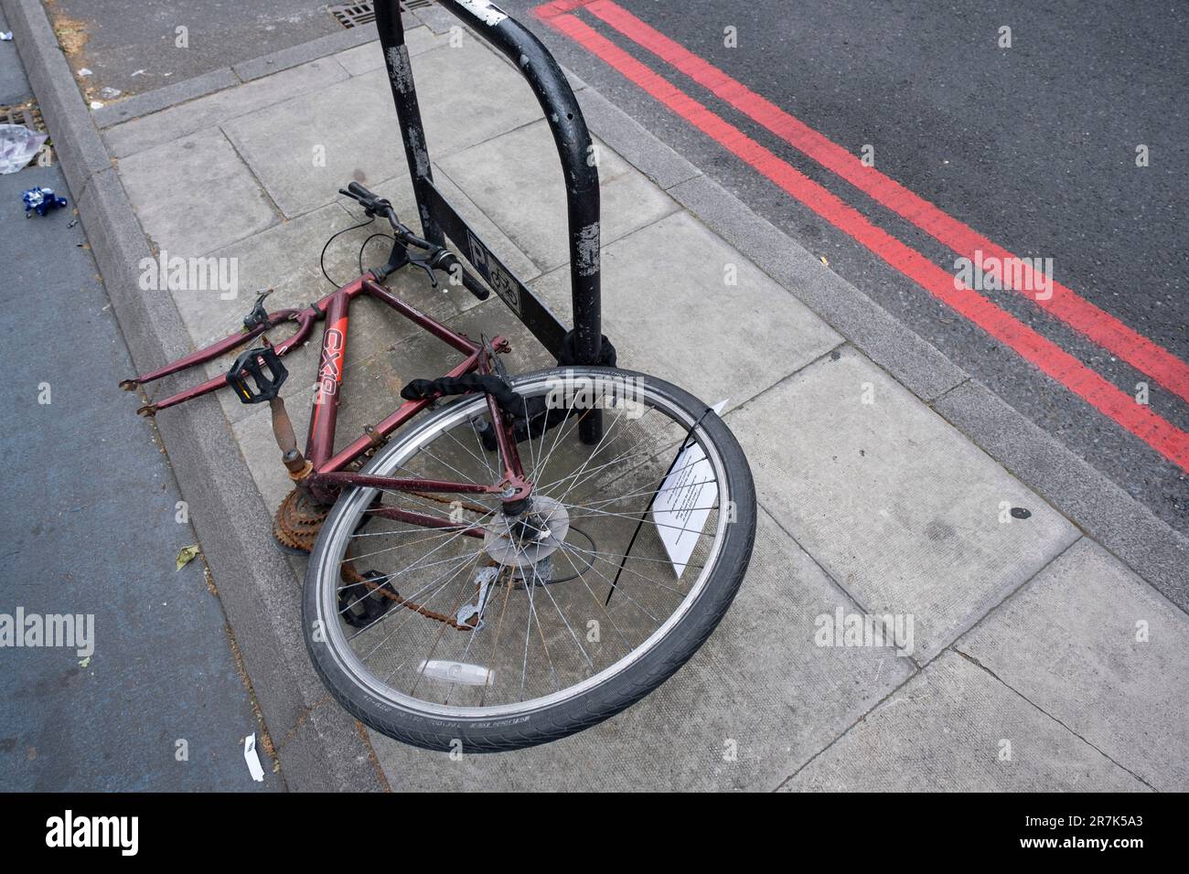 Bicycle which has been locked to bike stand for a long time and causing an obstruction, receive a TfL bike removal notice that they will be removed following a given period on 25th May 2023 in London, United Kingdom. Stock Photo