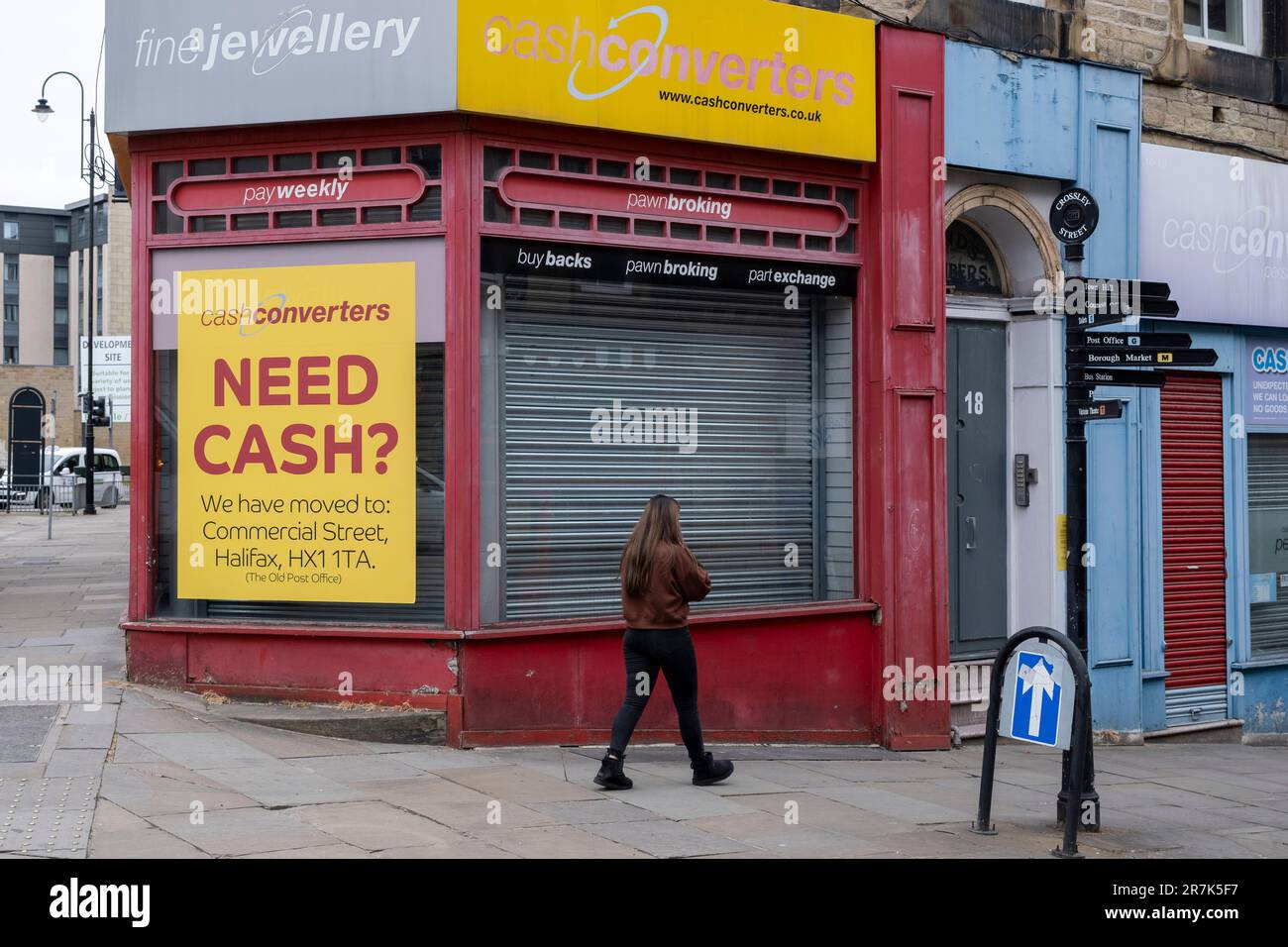 Closed down branch of Cash Converters displays a sign asking if anyone needs cash that their