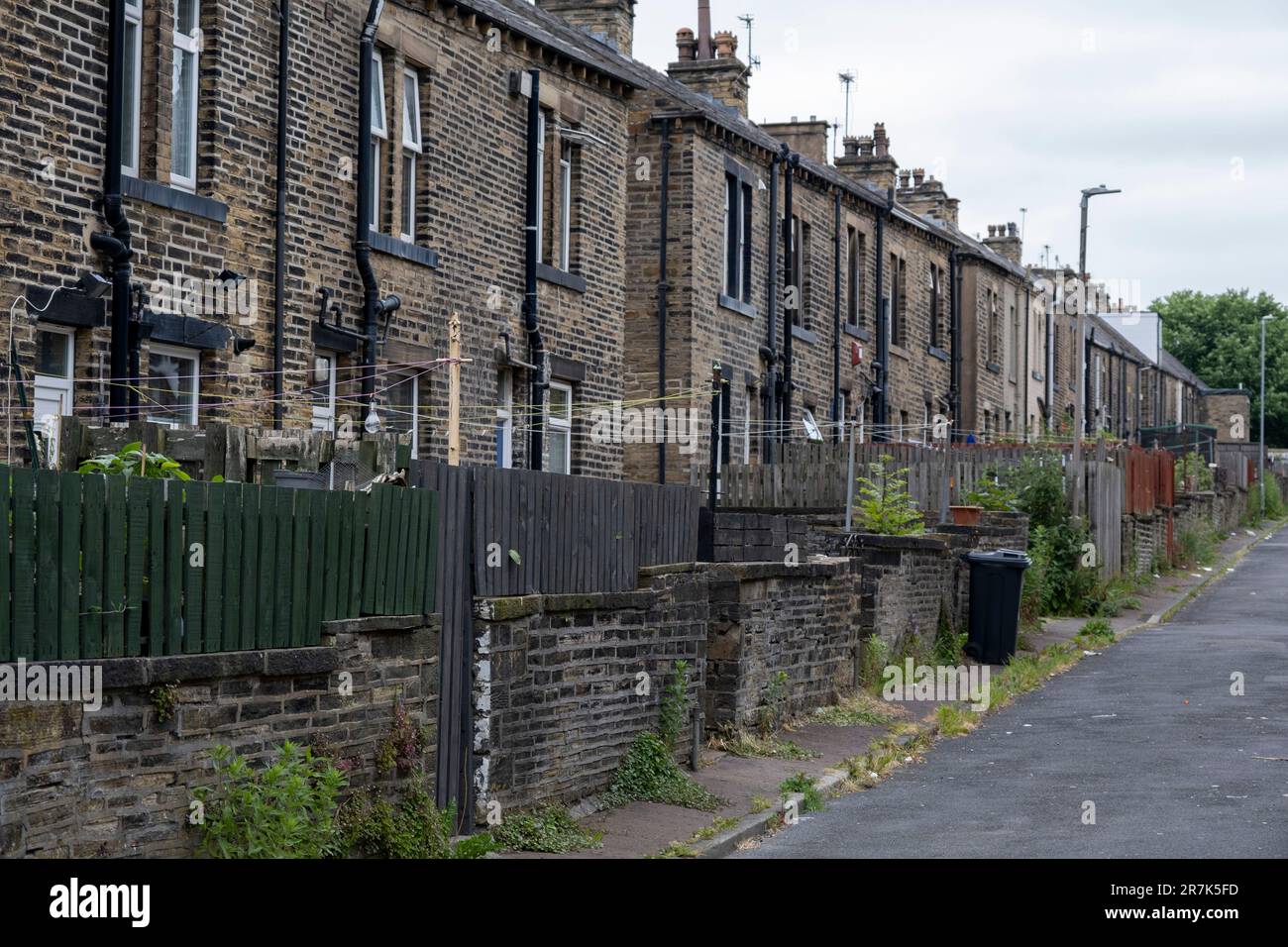 Back alley where bins are kept outside old mill workers cottages within