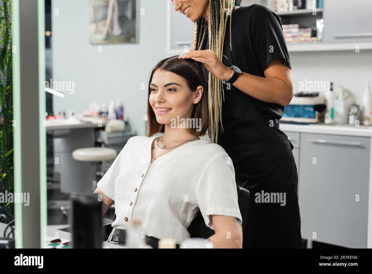 beauty salon work, happy hairdresser with braids and female client, hairstyling, hair treatment, hairdo, extension, salon customer, beauty profession, Stock Photo