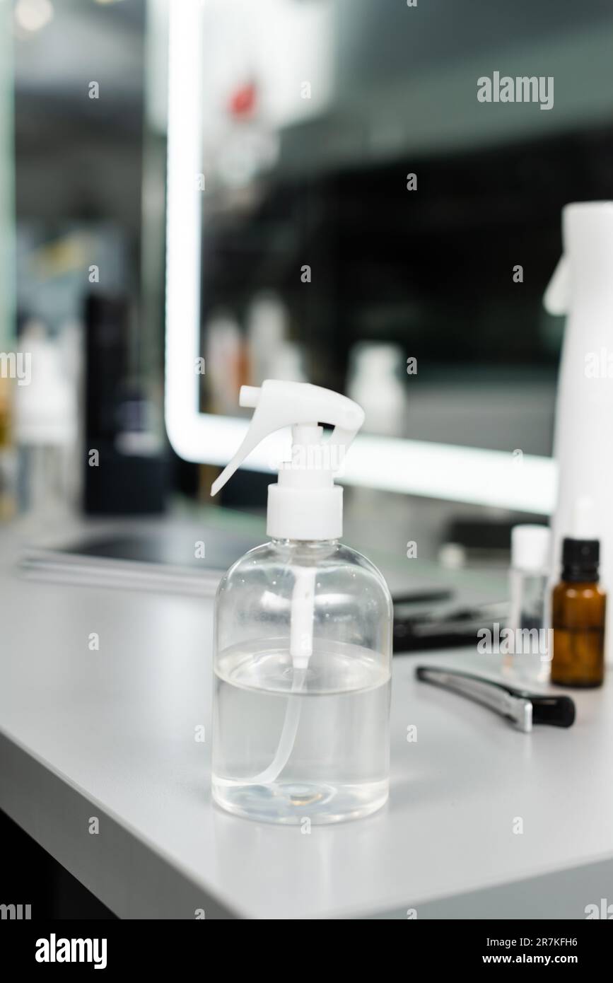 spray bottle with water, hairstyling equipment, salon services, hairstyling, hair trends, blurred background, beauty industry, hair care, professional Stock Photo