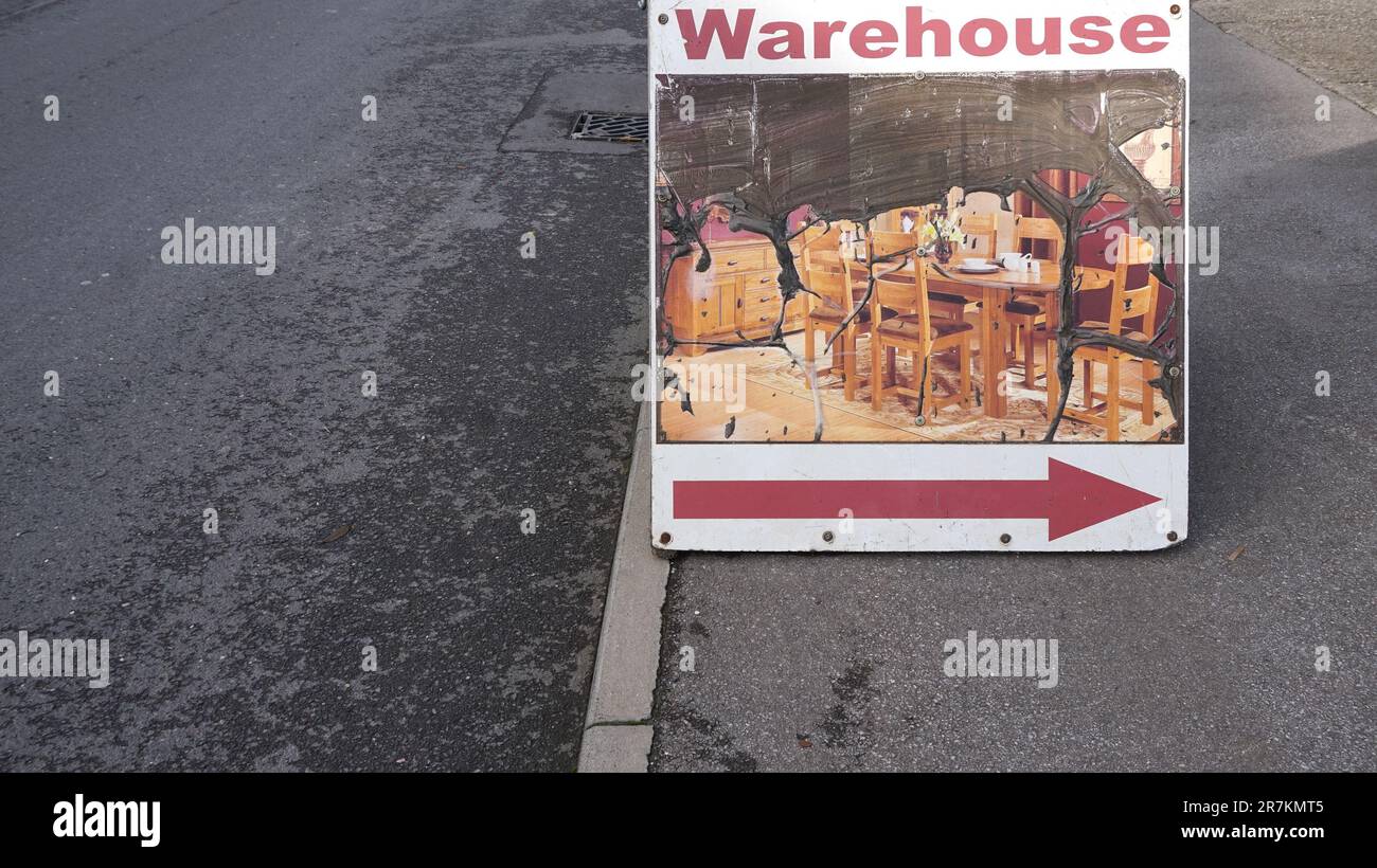 Industrial estate, pavement, street view of a decaying A board