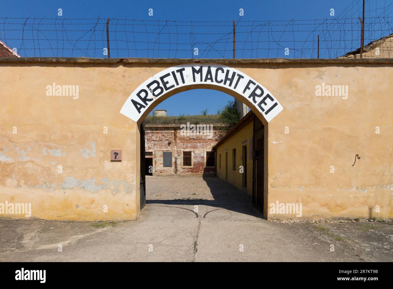 Gate with the slogan "Arbeit macht frei" in the Small Fortress of Terezín (Theresienstadt concentration camp) Stock Photo