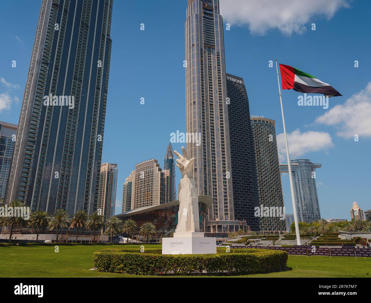 20 March 2023, Dubai, UAE three fingers statue near UAE flag in sunny