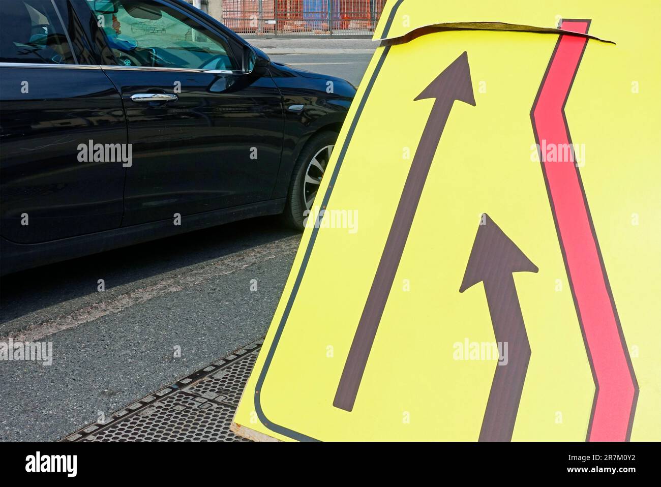 Merge left traffic sign Stock Photo - Alamy