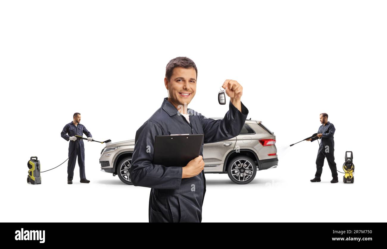 Carwash workers in uniforms washing a SUV with pressure washer machines