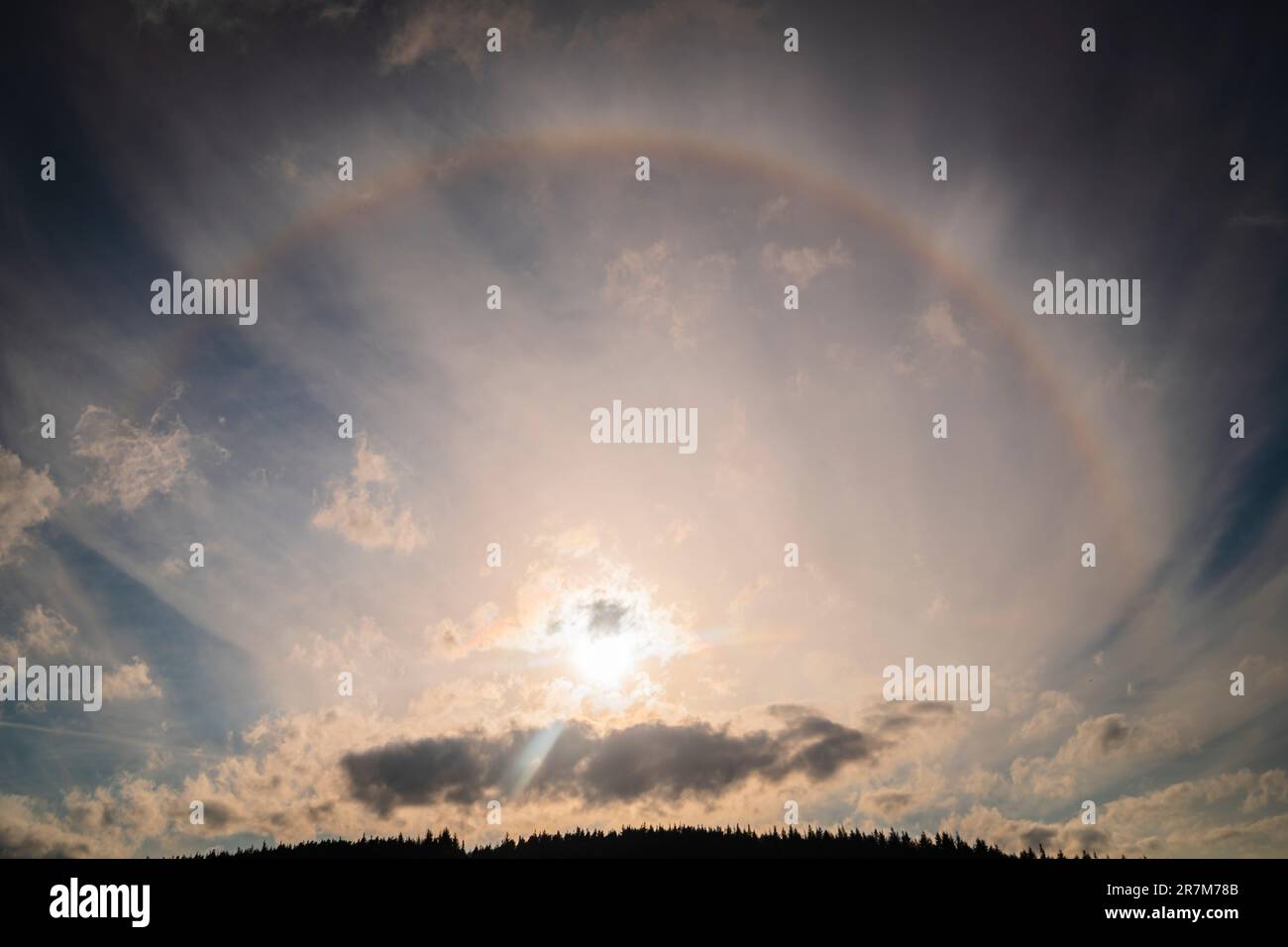 A HDR image of a Sun Halo or 22 Degree Halo, an Atmospheric phenomena caused by ice crystals refracting light in Cirrus clouds, Scotland.8th June 2023 Stock Photo