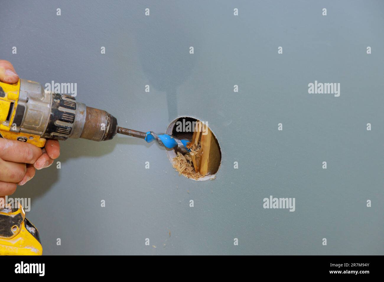 Drilling hole in the wall to beams for laying cable with renovation house Stock Photo