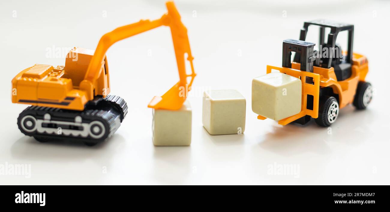 Toy bulldozer hold letter block  Stock Photo