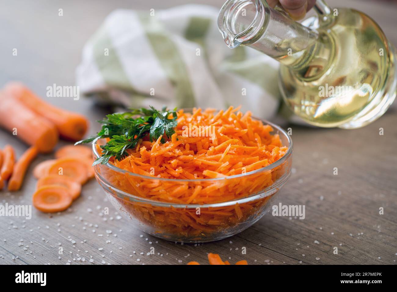 Salad with fresh carrot pouring oil Stock Photo
