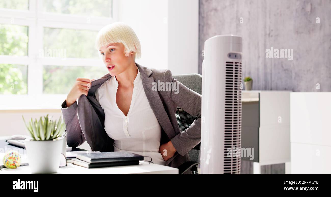 Electric Ventilator Fan In Hot Office Blowing Cool Breeze Stock Photo