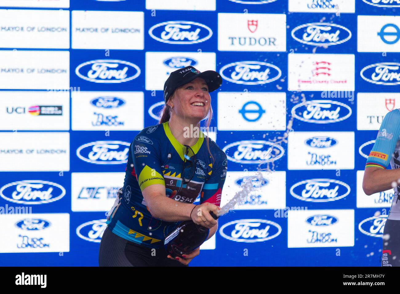 Charlotte Kool spraying champagne after winning the Classique UCI Women's WorldTour road race Stage 3 of the 2023 Ford RideLondon. Team DSM cyclist Stock Photo